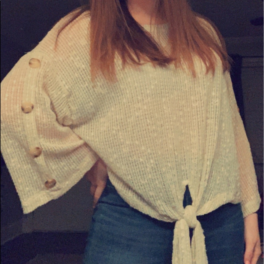 cream colored sweater with button sleeves